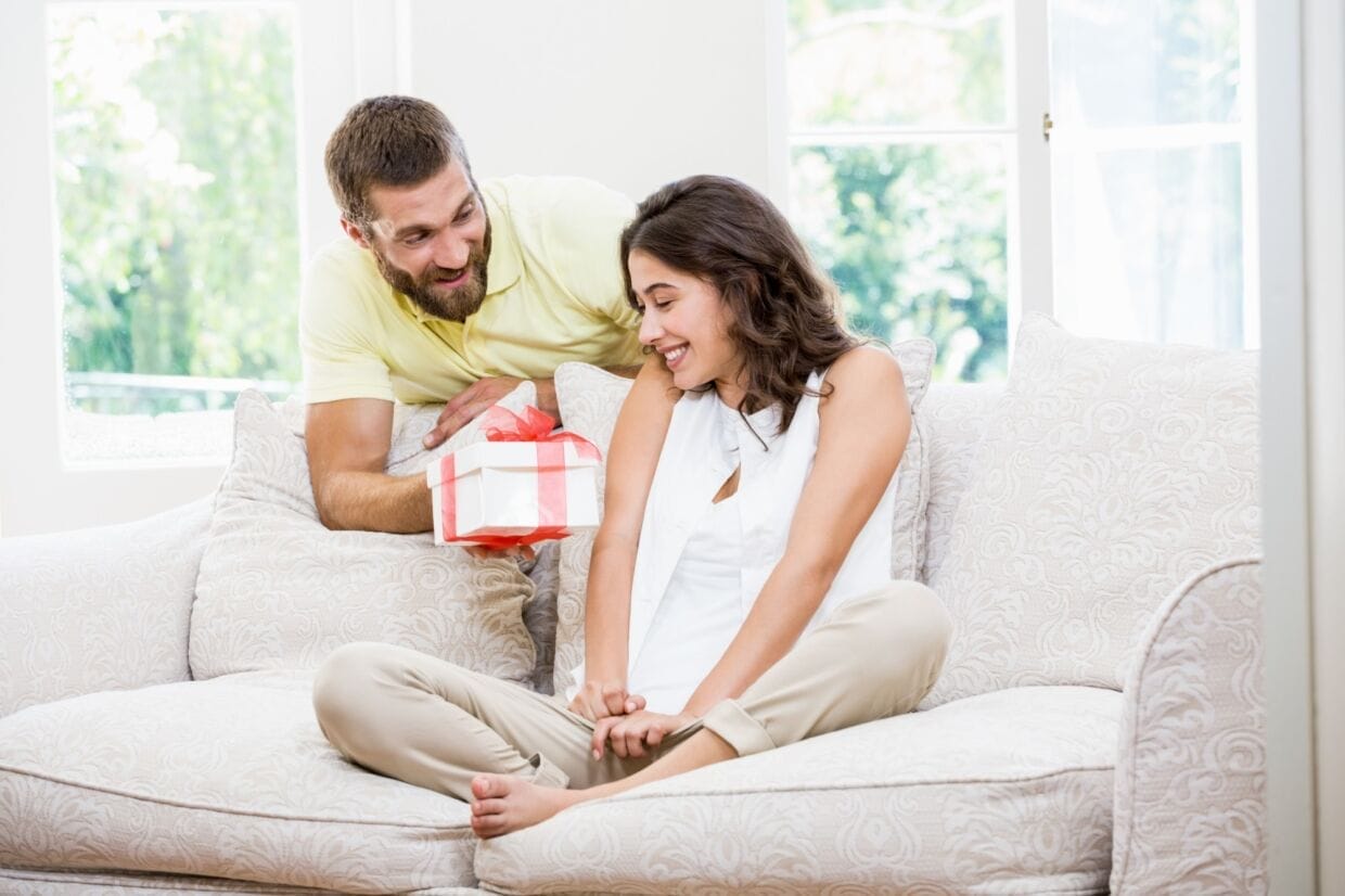 Man giving a surprise gift to her woman